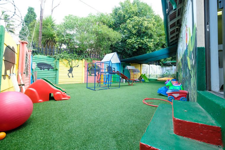 The toddler play area from another angle, with a large red ball and low climbing frame