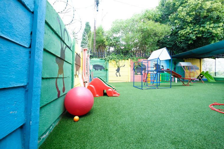 The separate, fenced play area for babies and toddlers, with a small slide and shade netting