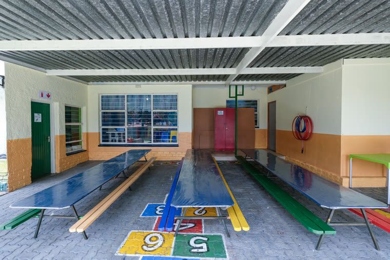The indoor hall, with hopscotch and number games painted on the floor and benches along the side